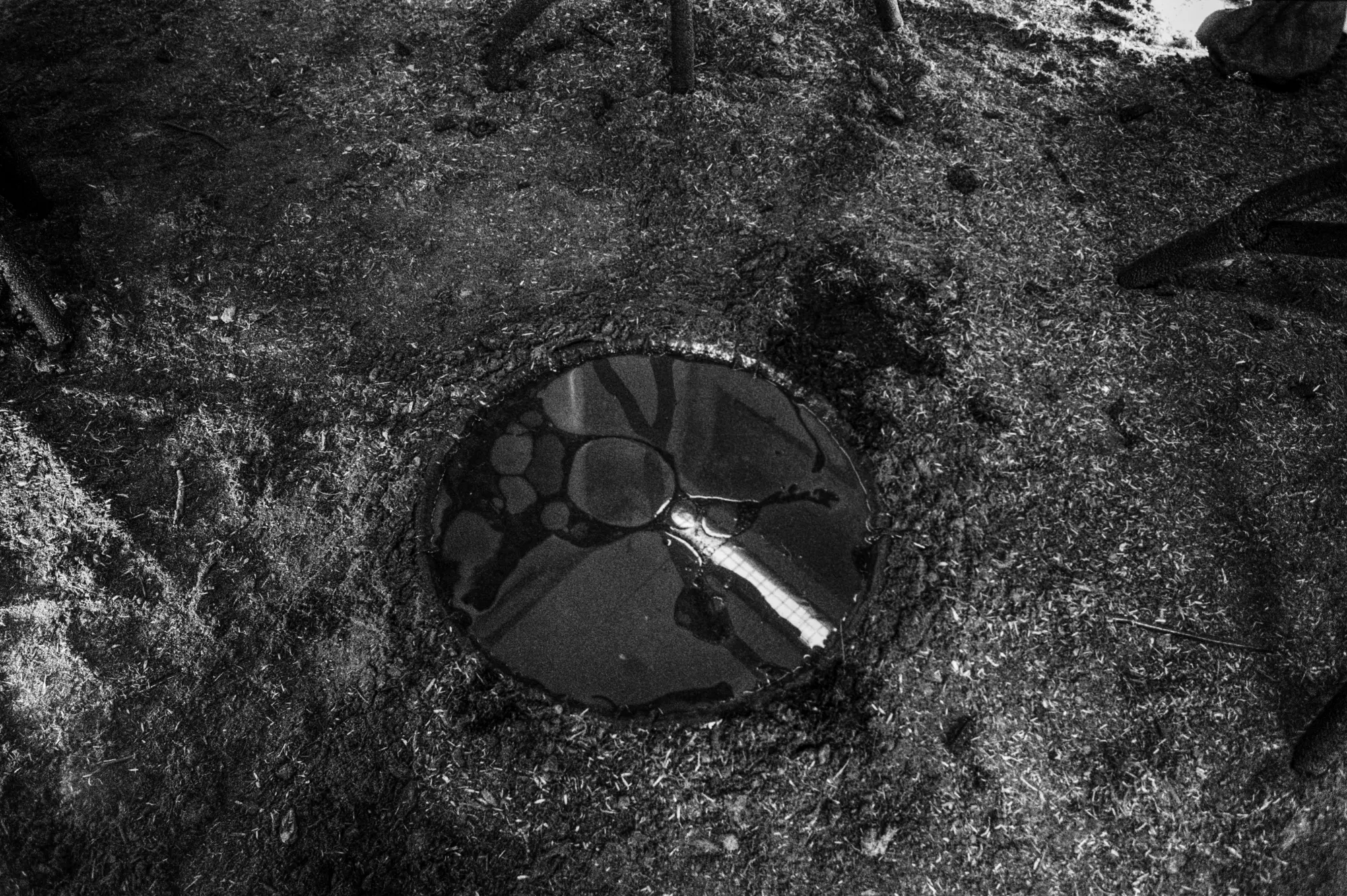 A pool set into the earth floor, seen from above